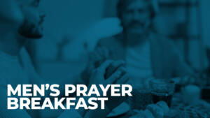 Men praying together at breakfast table