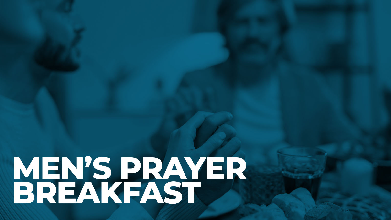 Men praying together at breakfast table