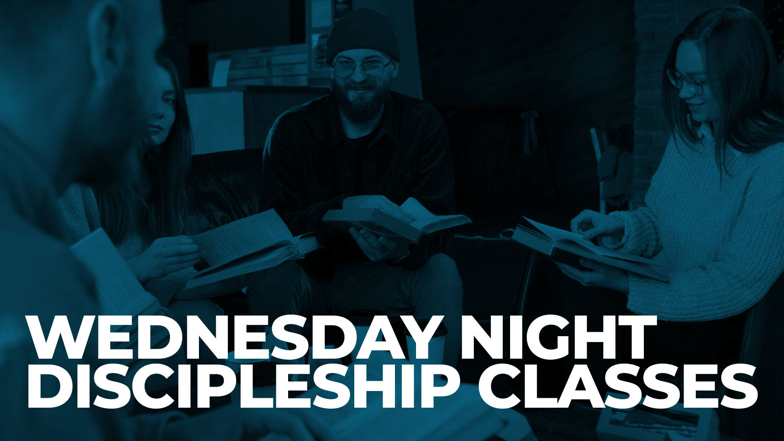 Adults study books in Wednesday night discipleship class