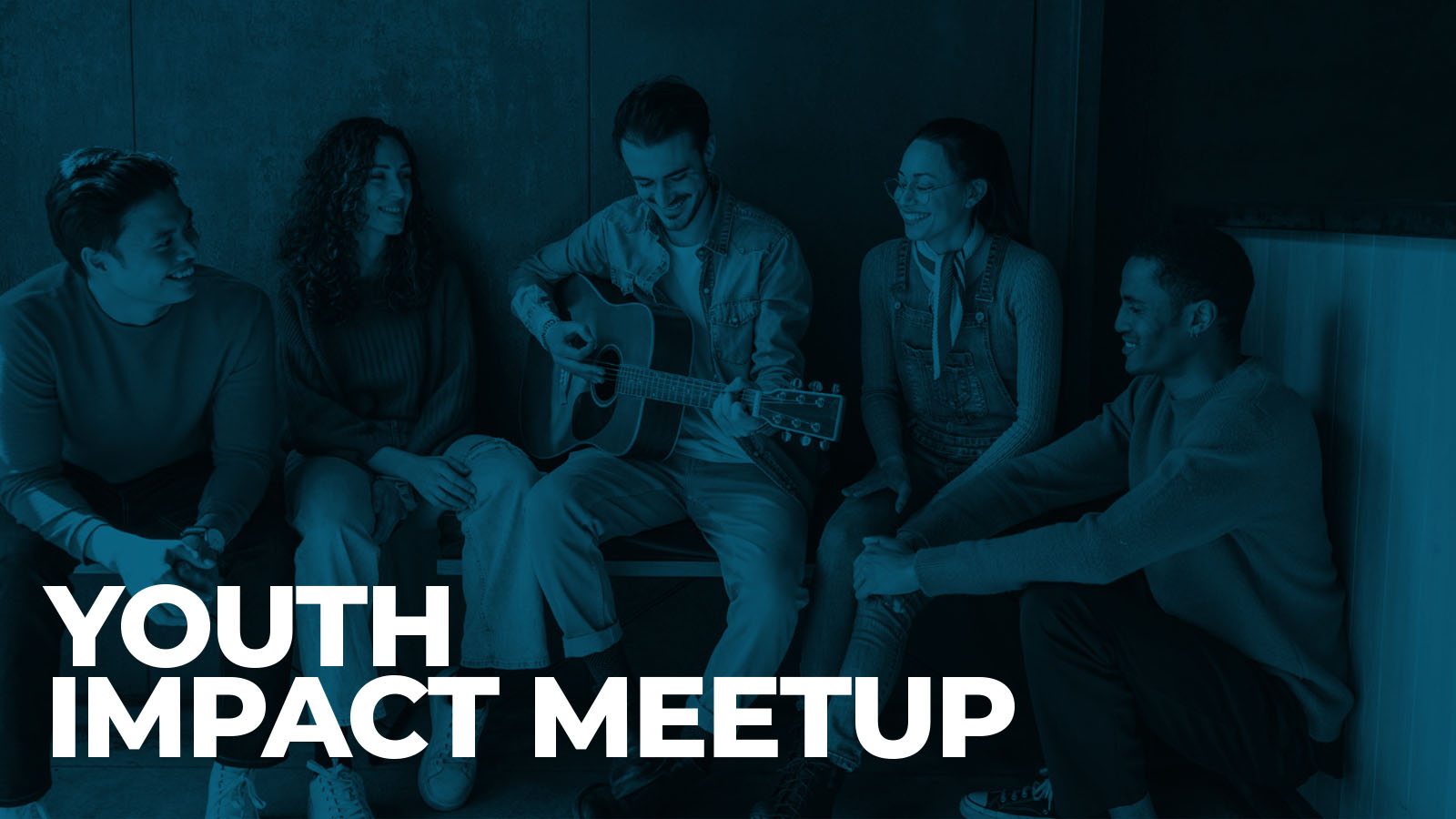 Young adults gather as one plays acoustic guitar